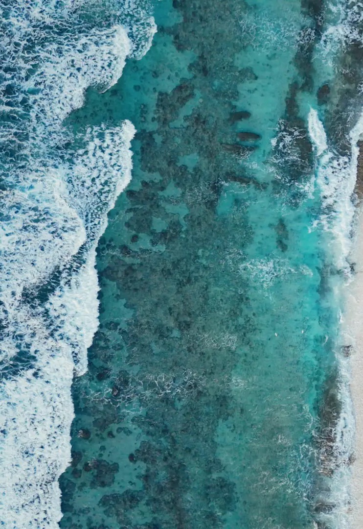 Aerial view of ocean swell breaking over a reef